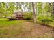 Backyard showcasing a home exterior, lush foliage, and a well-maintained lawn at 2199 Lookout Pt, Rock Hill, SC 29732