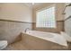 Relaxing bathroom with large tiled tub and glass block window for privacy and light at 2199 Lookout Pt, Rock Hill, SC 29732