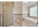 Bathroom with tiled shower and separate tiled tub with tiled walls at 2199 Lookout Pt, Rock Hill, SC 29732