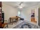 Bedroom featuring a ceiling fan, window, wooden desk and chair, plus decorative trunk and area rug at 2199 Lookout Pt, Rock Hill, SC 29732