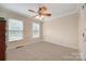 Empty bedroom with neutral carpeting, white trim and paint, and two large windows providing plenty of light at 2199 Lookout Pt, Rock Hill, SC 29732