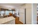 Eat-in kitchen with white cabinetry, tile countertops, and view to the dining room at 2199 Lookout Pt, Rock Hill, SC 29732