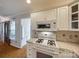 Traditional kitchen featuring white cabinetry, tile countertops, and modern gas range at 2199 Lookout Pt, Rock Hill, SC 29732
