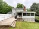 Rear exterior view of a home with a deck, porch and fenced yard at 2214 Cannonade Ct, Matthews, NC 28105