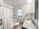 Bright bathroom features a tiled shower with safety bars, granite counter, and neutral decor at 2214 Cannonade Ct, Matthews, NC 28105