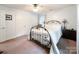 Cozy bedroom featuring an iron bed frame, neutral colored walls, ceiling fan, and great natural light at 2214 Cannonade Ct, Matthews, NC 28105
