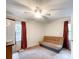 Comfortable bedroom with carpet, a ceiling fan, two windows, and a small sofa, providing a cozy space at 2214 Cannonade Ct, Matthews, NC 28105