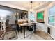 Bright breakfast nook with a wooden table, unique lighting fixture, and a view of the living room and stained glass window at 2214 Cannonade Ct, Matthews, NC 28105
