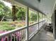 Relaxing front porch offers serene views of the neighborhood and the surrounding greenery with a decorative windchime at 2214 Cannonade Ct, Matthews, NC 28105
