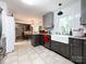Modern kitchen with stainless steel appliances, sleek gray cabinets, and a farmhouse sink overlooking the backyard at 2214 Cannonade Ct, Matthews, NC 28105