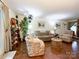 Bright living room with hardwood floors, comfortable furniture, and a large window that brings in ample natural light at 2214 Cannonade Ct, Matthews, NC 28105