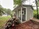 Outbuilding featuring a porch with seating and manicured grounds at 2214 Cannonade Ct, Matthews, NC 28105