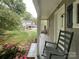 Close-up view of an outbuilding porch showing a chair and landscaped grounds at 2214 Cannonade Ct, Matthews, NC 28105