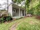 Cozy outbuilding with porch, seating, and beautiful landscaping at 2214 Cannonade Ct, Matthews, NC 28105