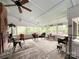 Spacious enclosed porch with ceiling fan, seating, and view of the greenery at 2214 Cannonade Ct, Matthews, NC 28105