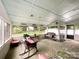 Enclosed porch featuring multiple seating areas, ceiling fan and view of the backyard at 2214 Cannonade Ct, Matthews, NC 28105