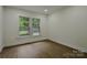 Bright bedroom featuring hardwood floors and natural light from a double-hung window at 307 E 2Nd St, Lowell, NC 28098