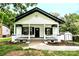 Inviting single-story home with a covered front porch, well-maintained landscaping, and a detached shed at 307 E 2Nd St, Lowell, NC 28098