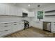 Modern kitchen featuring white cabinets, stainless steel appliances, and ample counter space at 307 E 2Nd St, Lowell, NC 28098