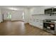 Well-designed kitchen with stainless steel appliances, white cabinets, and an open view into the dining area at 307 E 2Nd St, Lowell, NC 28098