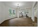 Open-concept living room showcasing hardwood floors, large windows, and seamless flow into the adjacent kitchen at 307 E 2Nd St, Lowell, NC 28098