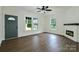 Well-lit living room boasting hardwood floors, a fireplace, and an entrance door with large windows at 307 E 2Nd St, Lowell, NC 28098