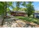 Expansive backyard with a picnic table and a glimpse of the charming brick home at 319 Hatley Ne Cir, Concord, NC 28025