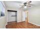 This bedroom includes a closet, hardwood floors, and a ceiling fan and light fixture at 319 Hatley Ne Cir, Concord, NC 28025
