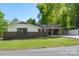 A charming brick home on a sunny day, featuring a carport and lush green lawn, offering serene suburban living at 319 Hatley Ne Cir, Concord, NC 28025