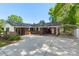 Brick home with a covered carport, bench seating, and well-kept landscaping, offering a welcoming and practical design at 319 Hatley Ne Cir, Concord, NC 28025