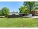 Charming brick home with a well-manicured lawn, covered carport, and lovely landscaping creating welcoming curb appeal at 319 Hatley Ne Cir, Concord, NC 28025