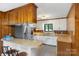 Open kitchen design with breakfast bar seating and stainless steel refrigerator and appliances at 319 Hatley Ne Cir, Concord, NC 28025