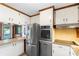 A bright kitchen featuring stainless steel appliances, wood trim details, and breakfast bar at 319 Hatley Ne Cir, Concord, NC 28025