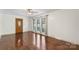 Inviting living room with polished hardwood floors, large windows, and a classic ceiling fan, offering a cozy and bright space at 319 Hatley Ne Cir, Concord, NC 28025
