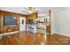 An open living room flows to kitchen with hardwood floors and natural light at 319 Hatley Ne Cir, Concord, NC 28025