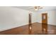 Bright living room with hardwood floors, white walls, and classic ceiling fan, creating a warm and inviting atmosphere at 319 Hatley Ne Cir, Concord, NC 28025