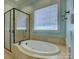Luxurious bathroom with soaking tub, tiled surround, and separate glass-enclosed shower at 324 Quinby Way, Rock Hill, SC 29732