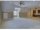 Large bonus room with neutral carpet and a wet bar, offering versatile space for entertainment and relaxation at 324 Quinby Way, Rock Hill, SC 29732