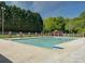 Outdoor community pool surrounded by a fence and mature trees and manicured shrubs at 324 Quinby Way, Rock Hill, SC 29732