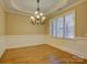 Traditional dining room with hardwood floors, elegant chandelier, and large window at 324 Quinby Way, Rock Hill, SC 29732
