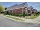 Well-maintained brick building with lush landscaping and mature bushes, offering a welcoming curb appeal at 324 Quinby Way, Rock Hill, SC 29732