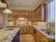 Gourmet kitchen featuring granite countertops, stainless steel appliances, and custom cabinetry at 324 Quinby Way, Rock Hill, SC 29732