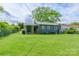 Well-maintained lawn in fenced backyard, complemented by a charming covered patio for relaxed outdoor enjoyment at 400 Rhyne St, Stanley, NC 28164