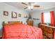 Charming bedroom featuring a ceiling fan, natural light, and wooden furniture at 400 Rhyne St, Stanley, NC 28164