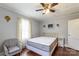Inviting bedroom featuring hardwood floors, a ceiling fan, and a comfortable seating area by the natural light window at 400 Rhyne St, Stanley, NC 28164