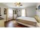 Bright bedroom with hardwood floors, ceiling fan, and decorative accents creating a comfortable and stylish space at 400 Rhyne St, Stanley, NC 28164