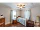 Charming bedroom with hardwood floors, a cozy bed, and plenty of natural light from the windows at 400 Rhyne St, Stanley, NC 28164