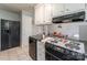 Practical kitchen with ample countertop space, black appliances, white tile floors, and plenty of storage at 400 Rhyne St, Stanley, NC 28164