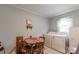 Bright laundry area equipped with a washer, dryer, and small dining table; adjacent to kitchen at 400 Rhyne St, Stanley, NC 28164