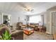 Inviting living room featuring a neutral palette, carpeted floors, ample seating, and natural light at 400 Rhyne St, Stanley, NC 28164